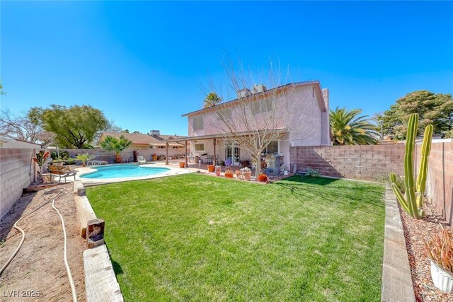 view of yard featuring a fenced in pool, a fenced backyard, and a patio area