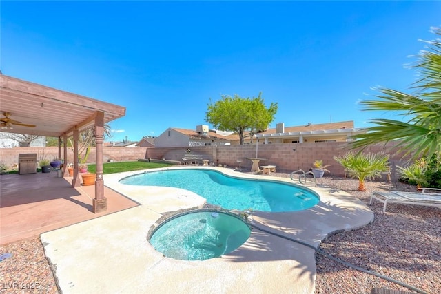 view of swimming pool with a patio area, ceiling fan, a pool with connected hot tub, and a fenced backyard