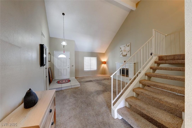 carpeted entryway featuring stairway, baseboards, visible vents, high vaulted ceiling, and beam ceiling