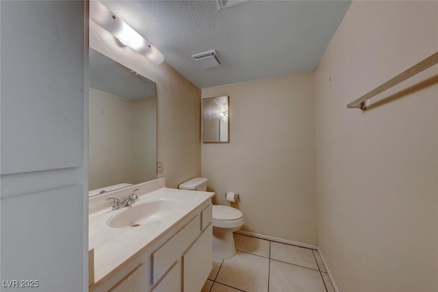 bathroom with visible vents, toilet, a textured ceiling, tile patterned flooring, and vanity