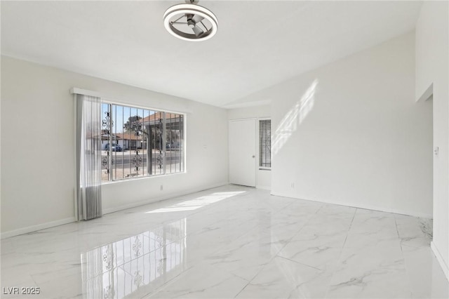 empty room with marble finish floor and baseboards