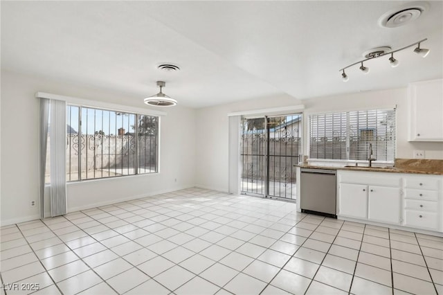 kitchen with light tile patterned floors, visible vents, white cabinetry, a sink, and dishwasher