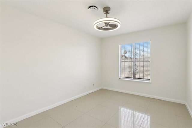 unfurnished room featuring light tile patterned floors, visible vents, baseboards, and a ceiling fan