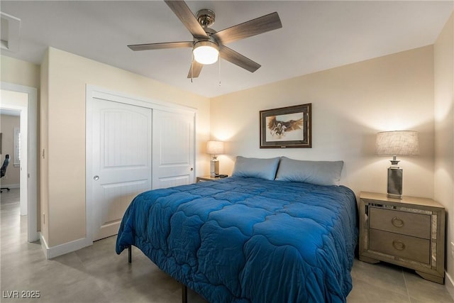 bedroom with a closet, baseboards, and a ceiling fan