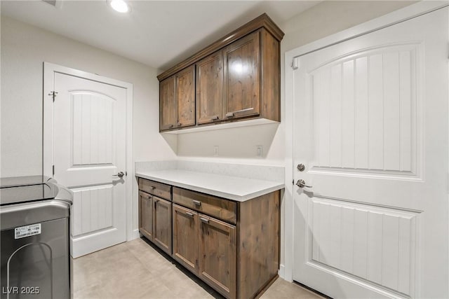 clothes washing area with cabinet space