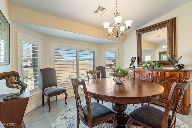 dining area with vaulted ceiling, baseboards, visible vents, and a chandelier