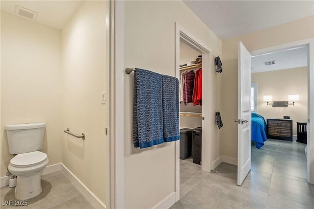 bathroom with visible vents, baseboards, and toilet