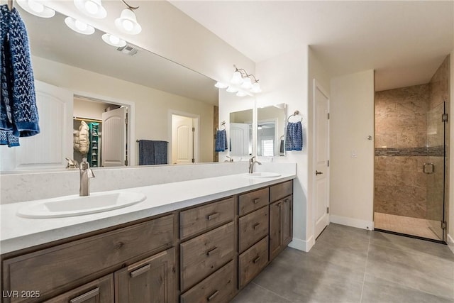 full bathroom featuring a shower stall, double vanity, visible vents, and a sink