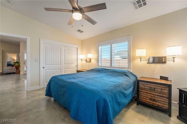 bedroom with visible vents, lofted ceiling, a closet, and a ceiling fan