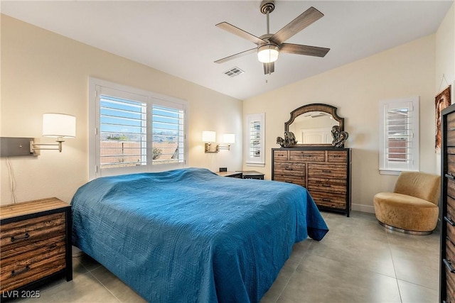 tiled bedroom featuring visible vents, lofted ceiling, baseboards, and a ceiling fan