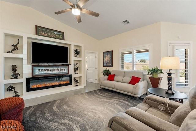 living area with built in features, visible vents, lofted ceiling, ceiling fan, and a glass covered fireplace