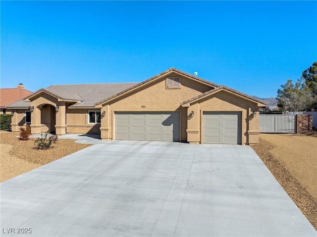 ranch-style house featuring fence, an attached garage, stucco siding, concrete driveway, and a tiled roof