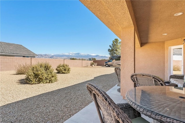 view of yard with a mountain view, a patio, and a fenced backyard