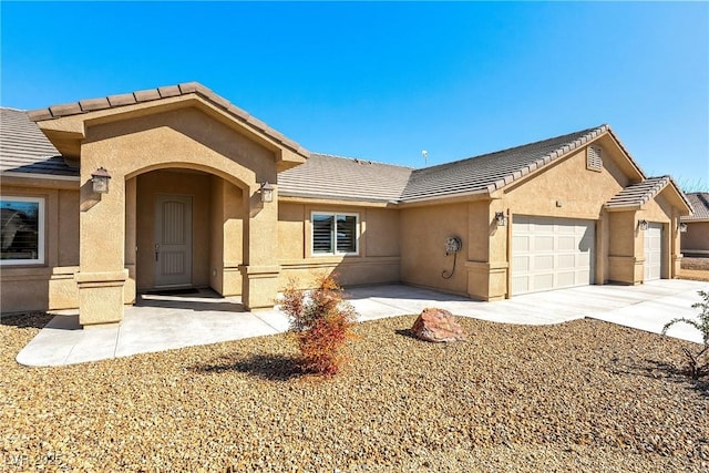 ranch-style home featuring stucco siding, a garage, driveway, and a tiled roof