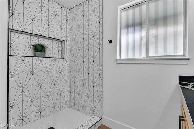 bathroom with a tile shower