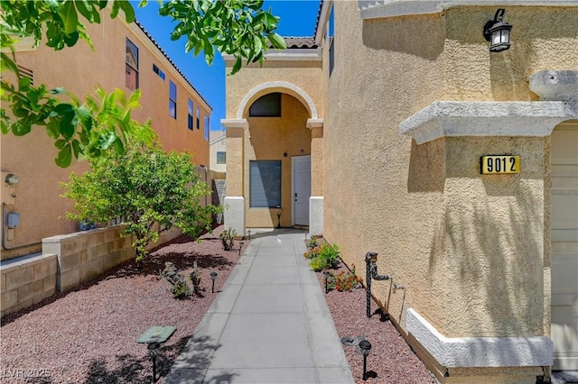 entrance to property with stucco siding