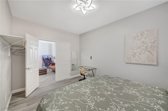 bedroom with wood finished floors and baseboards