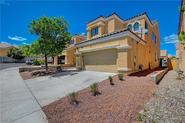 view of front facade with stucco siding, a garage, concrete driveway, and a tile roof