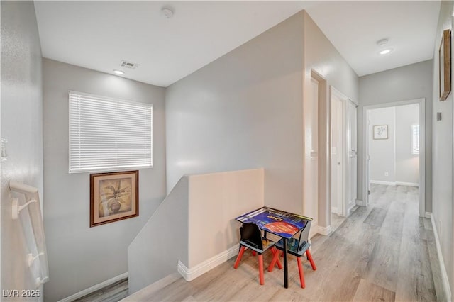 hall featuring visible vents, an upstairs landing, wood finished floors, recessed lighting, and baseboards