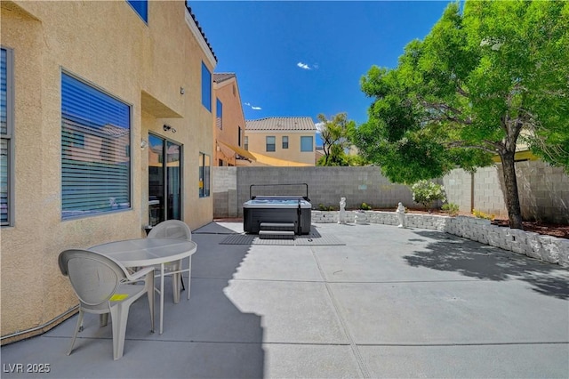 view of patio / terrace with a fenced backyard and a hot tub