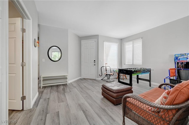 interior space featuring light wood-type flooring and baseboards