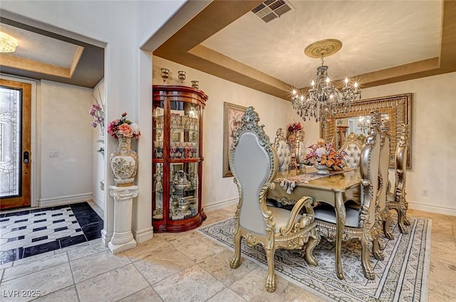 dining space featuring visible vents, baseboards, a raised ceiling, and an inviting chandelier