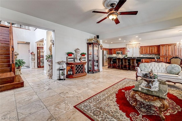 living room with stairway, recessed lighting, baseboards, and ceiling fan