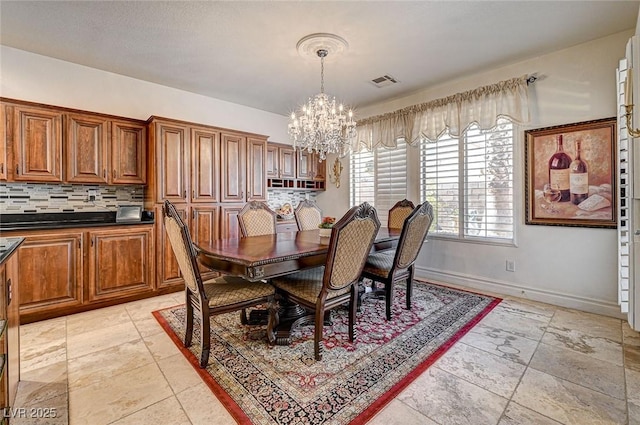 dining room featuring visible vents, baseboards, and an inviting chandelier