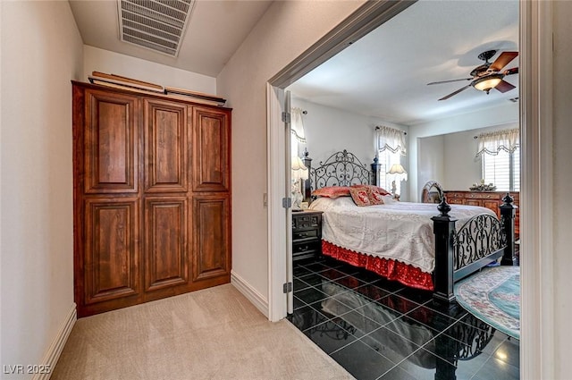 bedroom with visible vents, baseboards, carpet, and ceiling fan