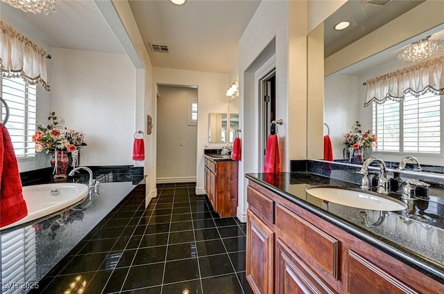 bathroom with visible vents, two vanities, a sink, tile patterned floors, and a bath