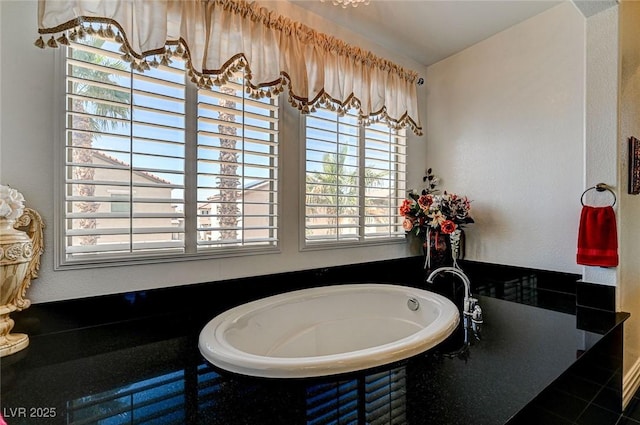 bathroom with tile patterned flooring and a washtub