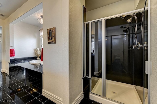 full bathroom featuring visible vents, baseboards, a textured wall, and a stall shower