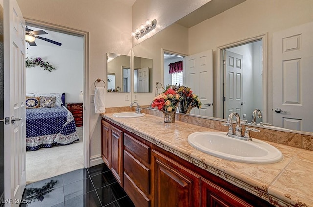 ensuite bathroom with double vanity, tile patterned flooring, ensuite bath, and a sink