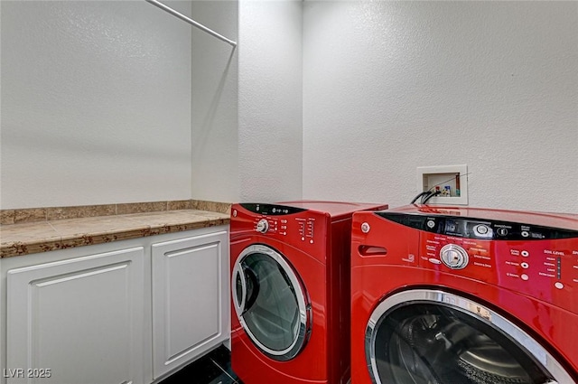 washroom with cabinet space and independent washer and dryer