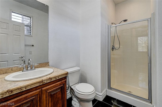 bathroom featuring tile patterned floors, vanity, toilet, and a shower stall