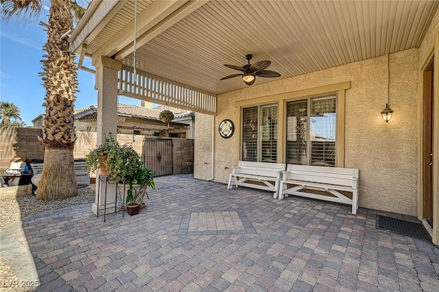 view of patio / terrace with a ceiling fan and fence