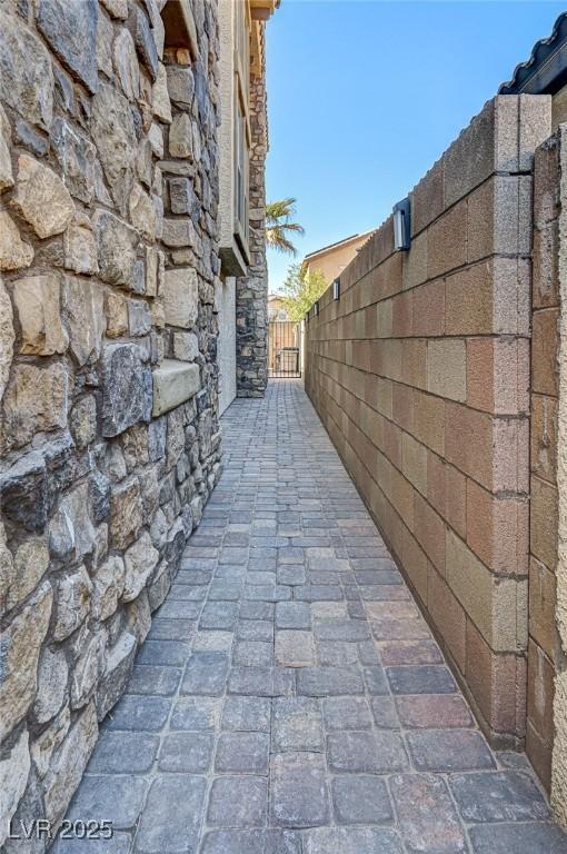 exterior space with fence and stone siding