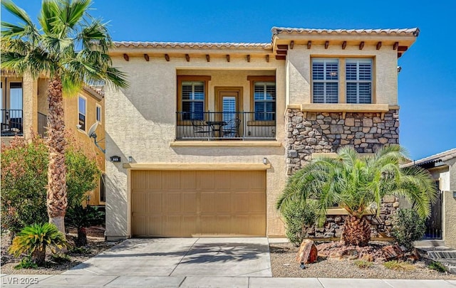 mediterranean / spanish-style home featuring a balcony, an attached garage, stucco siding, concrete driveway, and stone siding