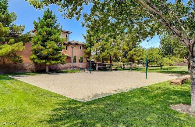 surrounding community featuring a lawn and volleyball court