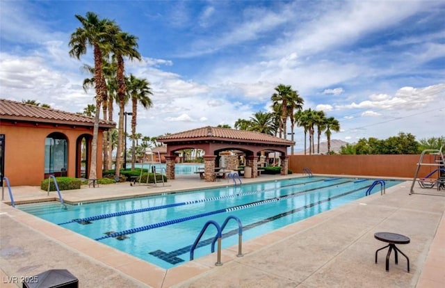 pool featuring a patio area and fence