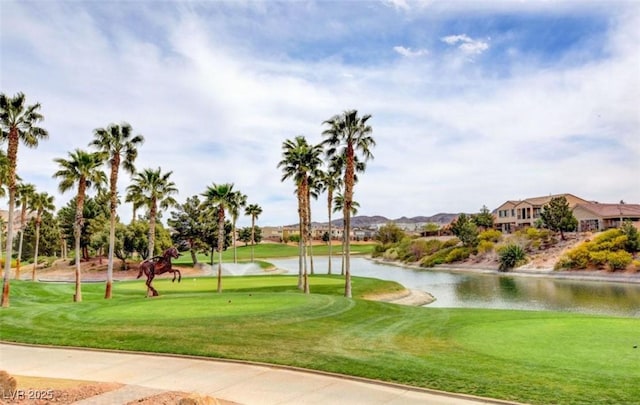 surrounding community featuring a yard, golf course view, and a water view