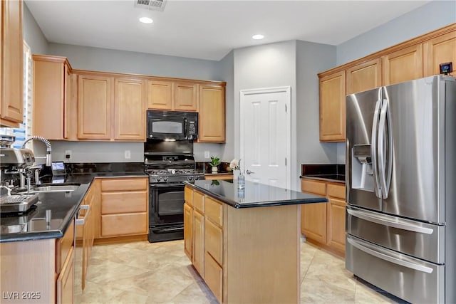 kitchen featuring light brown cabinets, a center island, recessed lighting, black appliances, and a sink