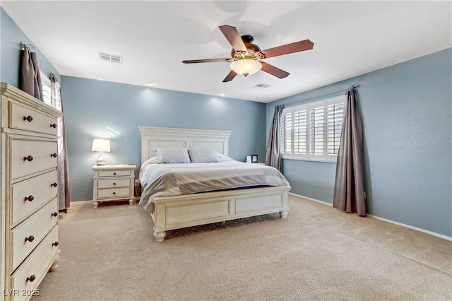 bedroom featuring visible vents, baseboards, light colored carpet, and ceiling fan