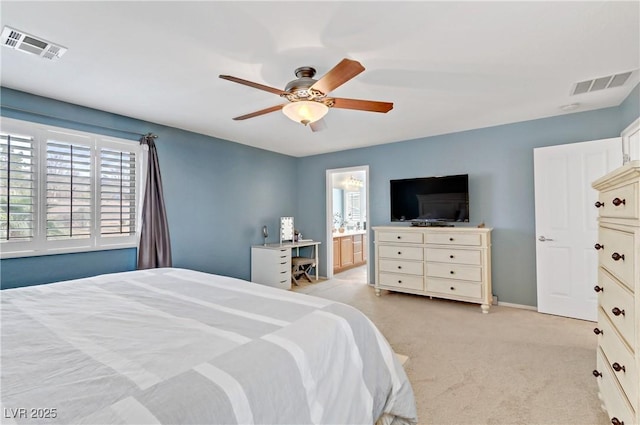 bedroom with ceiling fan, ensuite bath, visible vents, and light carpet