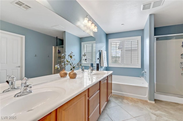 bathroom with visible vents, a shower stall, and a sink