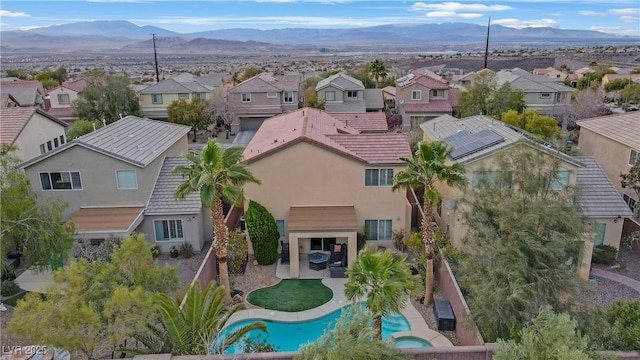 birds eye view of property with a mountain view and a residential view