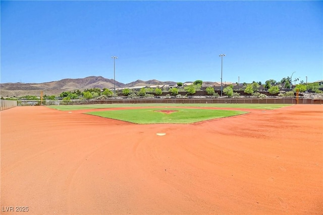 view of property's community featuring a mountain view and fence