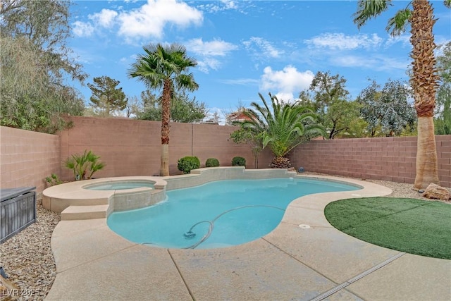 view of pool with a fenced backyard and a pool with connected hot tub