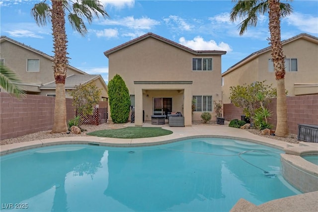 view of swimming pool with a patio, a pool with connected hot tub, a fenced backyard, and an outdoor hangout area