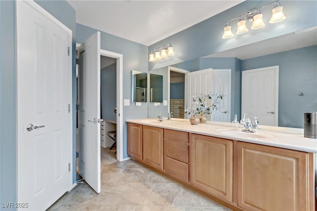 full bath with double vanity, tile patterned floors, and a sink